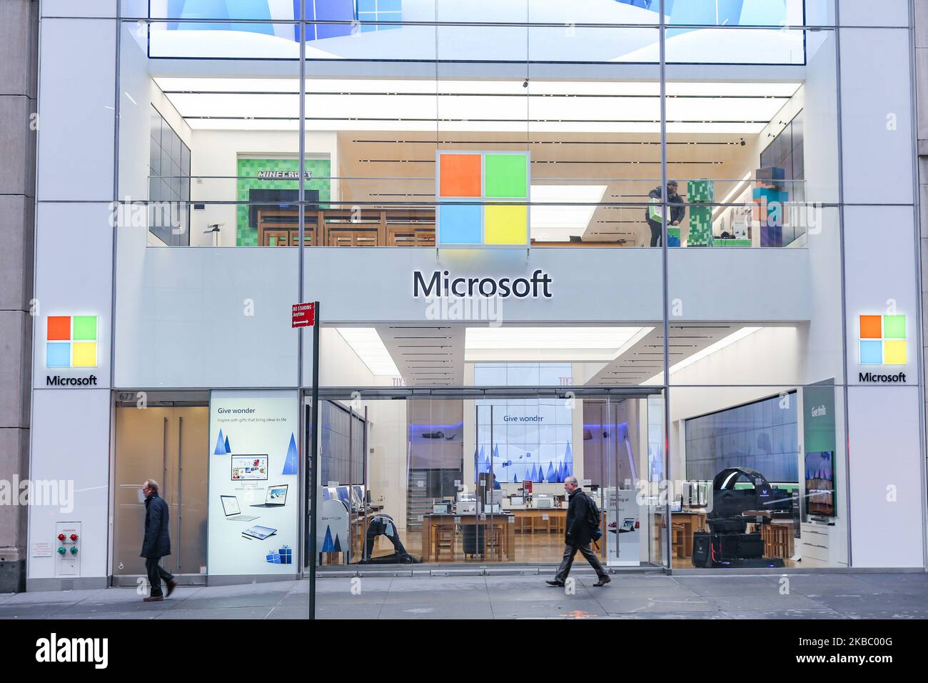 People walk past a Microsoft store entrance with the company's logo on top in midtown Manhattan at the 5th avenue in New York City, US, on 11 November 2019. Microsoft Corporation is world's largest software maker dominant in PC operating system Microsoft Windows, office applications, web browser and communication market. (Photo by Nicolas Economou/NurPhoto) Stock Photo