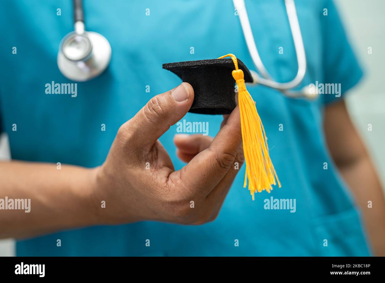 Doctoe Graduation Asian doctor study learn with graduation gap hat in hospital ward ...