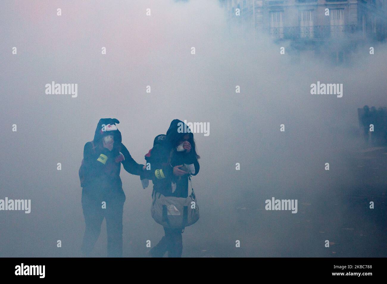 Paris, France, December 5, 2019. Demonstrators in the smoke of tear gas during clashes between black block and police at the demonstration against the government's pension reform project and to defend public service. (Photo by Emeric Fohlen/NurPhoto) Stock Photo