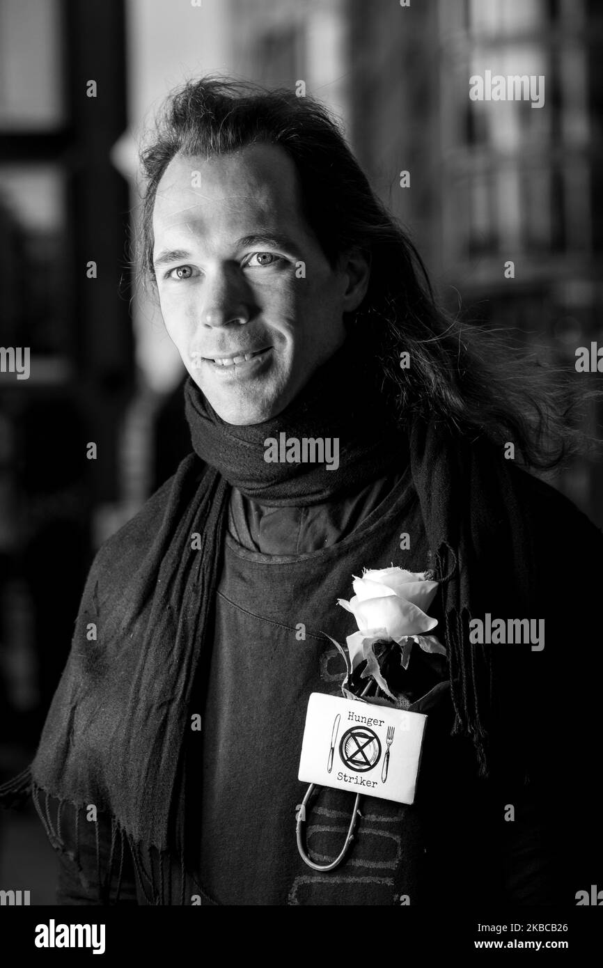 (EDITOR'S NOTE: Image was converted to black and white) Julian May, a member of Extinction Rebellion environmental organisation, on hunger strike for 20th cautious day, protests in front of Labour party headquarters in London, England on December 7, 2019. Group of members of the organisation decided to go on hunger strike to put pressure on UK's politicians before snap general election in the UK to focus on environmental emergency. Extinction Rebellion have put forward what they call 3 demands bill. (Photo by Dominika Zarzycka/NurPhoto) Stock Photo