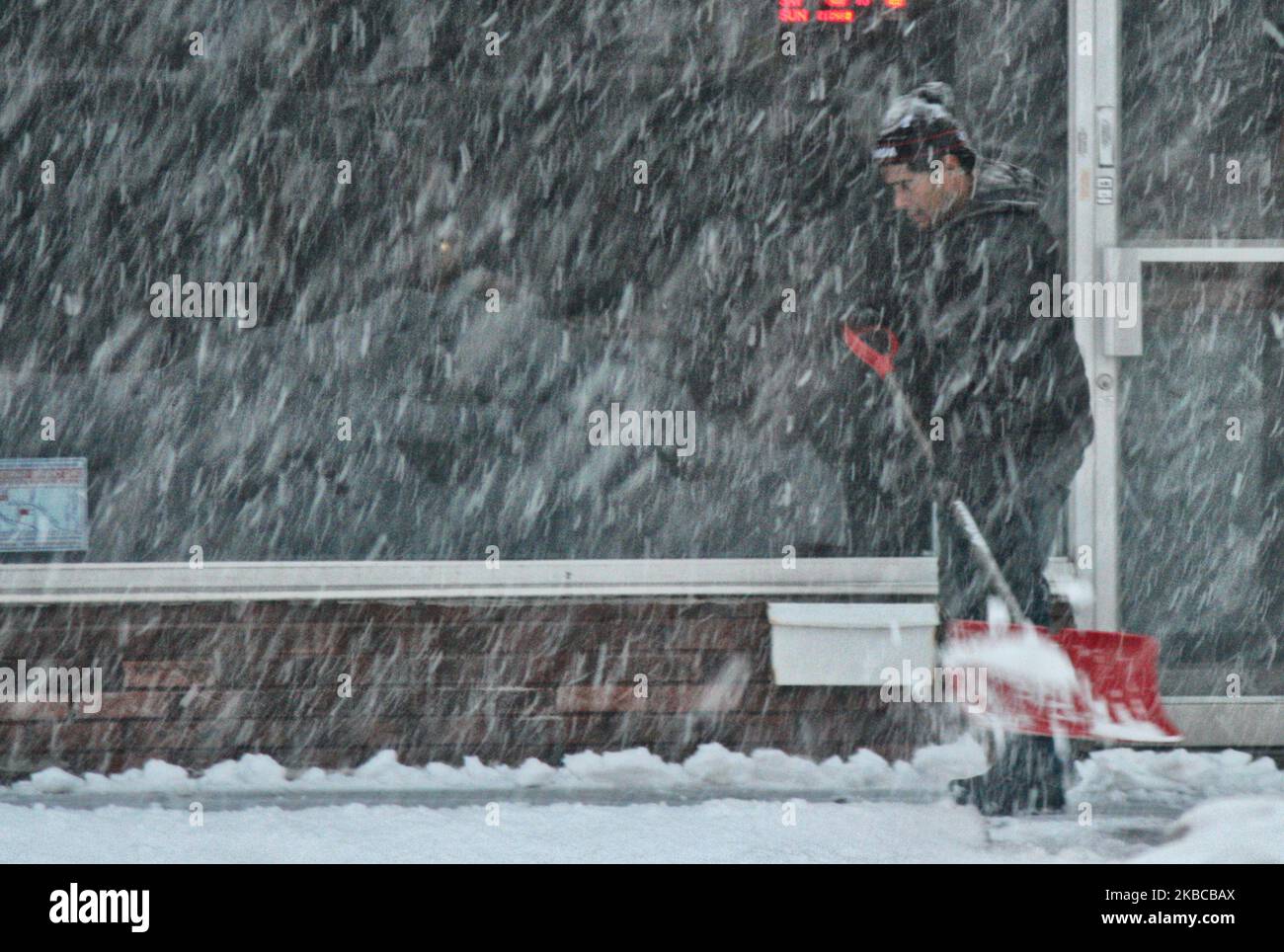 Man shovels snow as a massive snowstorm hit Toronto, Ontario, Canada ...
