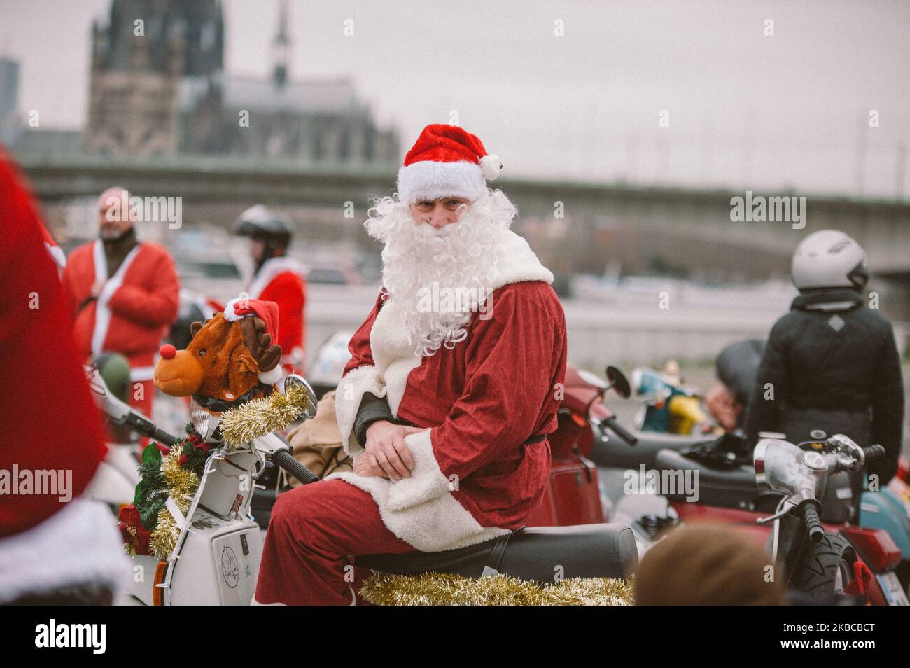 a man smiles at camera during the vespa christmas ride out event organized by Vespa Club RheinSchalter Köln in Cologne Germany on 7 December 2019. (Photo by Ying Tang/NurPhoto) Stock Photo