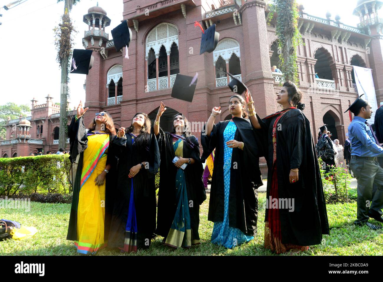 A group of graduates expressing their delight in front of the Curzon hall at university area, on the 52th convocation of the students of Dhaka University in Dhaka, Bangladesh, on December 8, 2019 (Photo by Mamunur Rashid/NurPhoto) Stock Photo
