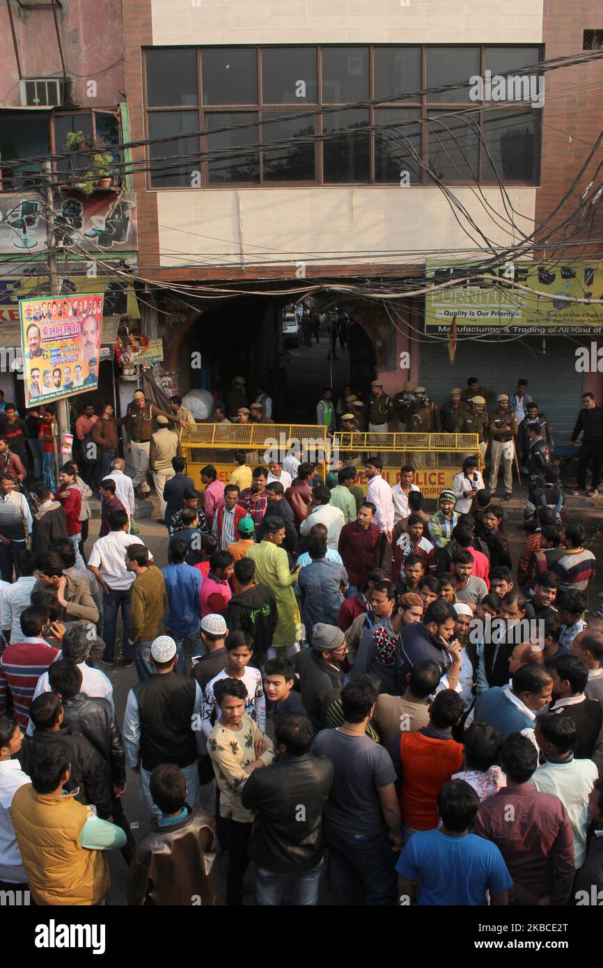 People gather at Anaj Mandi area near Rani Jhansi Road where a fire broke out during early morning hours in a plastic factory, on December 8, 2019 in New Delhi, India. Fire department personnel pulled 63 people during the rescue operation from 4-storey building while 43 causalities were reported till the last update. (Photo by Mayank Makhija/NurPhoto) Stock Photo