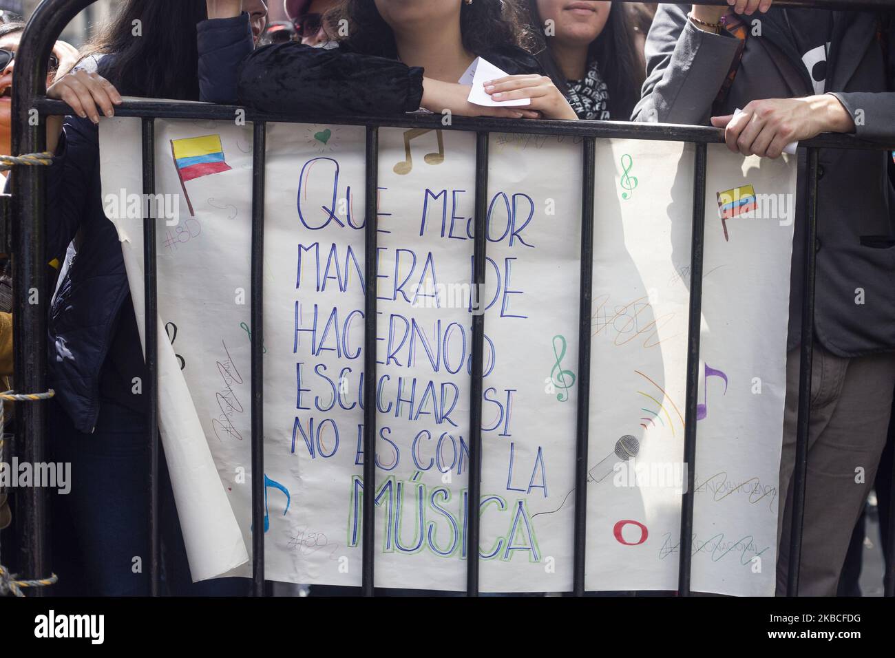 People hold a poster in a musical protest against the government of President Iván Duque in Bogotá. (Photo by Daniel Garzon Herazo/NurPhoto) Stock Photo