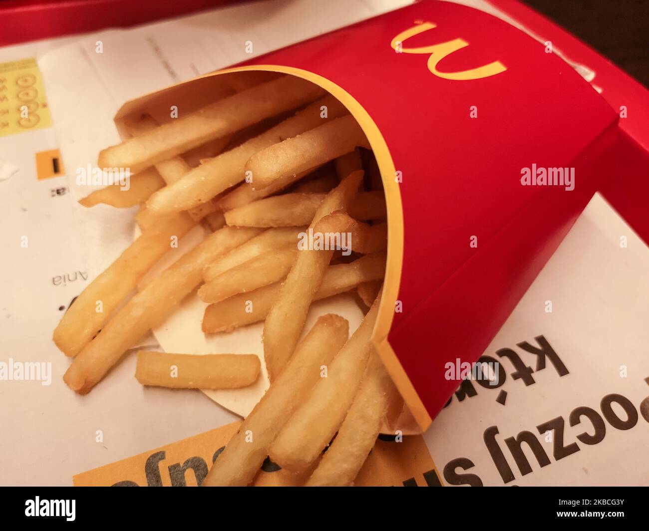 Woman eating fast food meal (cheeseburger , chips and Coca Cola) in McDonald's restaurant is seen in Gdynia, Poland on 9 December 2019 (Photo by Michal Fludra/NurPhoto) Stock Photo