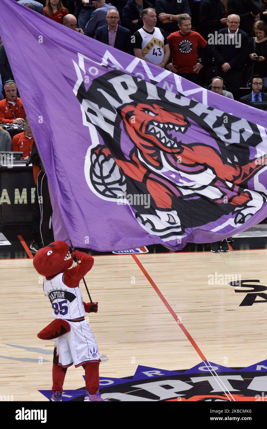 Toronto Raptors team mascot with a flag that depicts the old team logo during the Toronto Raptors vs Los Angeles Clippers NBA regular season game at Scotiabank Arena on December 11, 2019, in Toronto, Canada (Score after first half 46:64) (Photo by Anatoliy Cherkasov/NurPhoto) Stock Photo