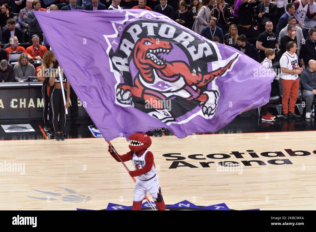 Toronto Raptors team mascot with a flag that depicts the old team logo during the Toronto Raptors vs Los Angeles Clippers NBA regular season game at Scotiabank Arena on December 11, 2019, in Toronto, Canada (Score after first half 46:64) (Photo by Anatoliy Cherkasov/NurPhoto) Stock Photo
