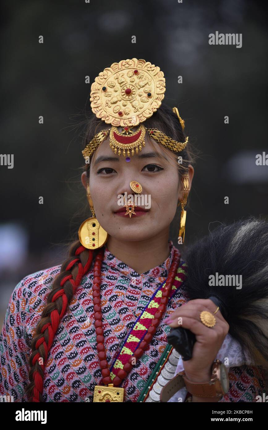 A Nepalese Kirant girl in traditional attire pose for the photos as ...