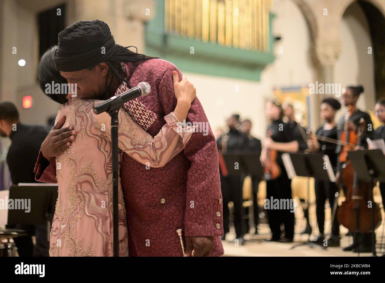 Dr. Kim Phc and Hannibal Lokumbe share a hug after the composer performed his 1973 composition Children of the Fire for the first time in the presence of Dr. Phc, in Philadelphia, PA, on December 7, 2019. Dr. Phc is the subject of the iconic 1972 Napalm Girl Pulitzer Prize-wining photograph by now-retired Associated Press photographer Nick Ut. (Photo by Bastiaan Slabbers/NurPhoto) Stock Photo