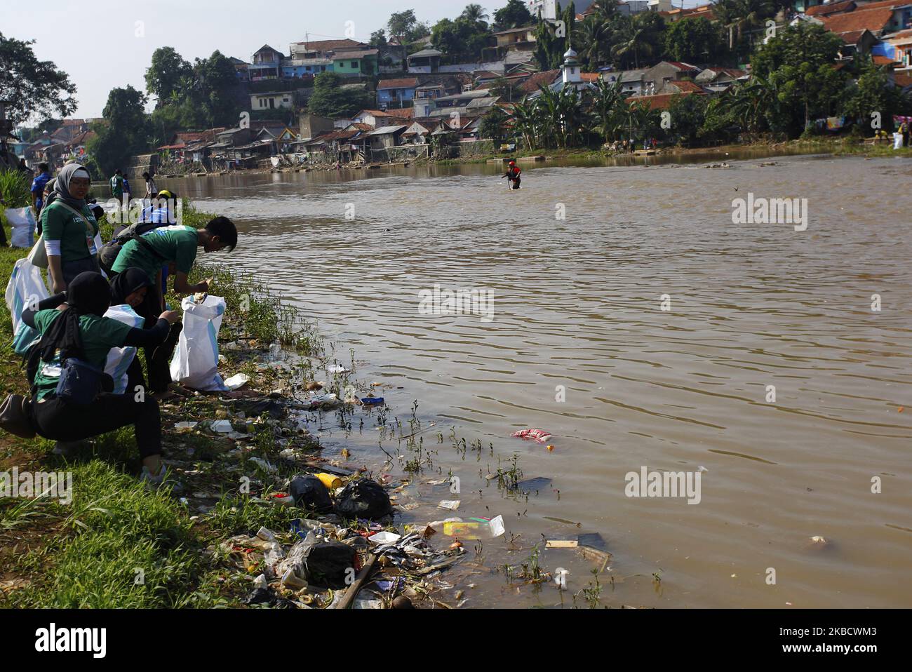 A Environmental volunteers collect waste in the Cisadane River, Bogor, West Java, on December 14, 2019. Activities to clean up waste in the river flow to anticipate flood disasters during the rainy season. (Photo by Adriana Adie/NurPhoto) Stock Photo