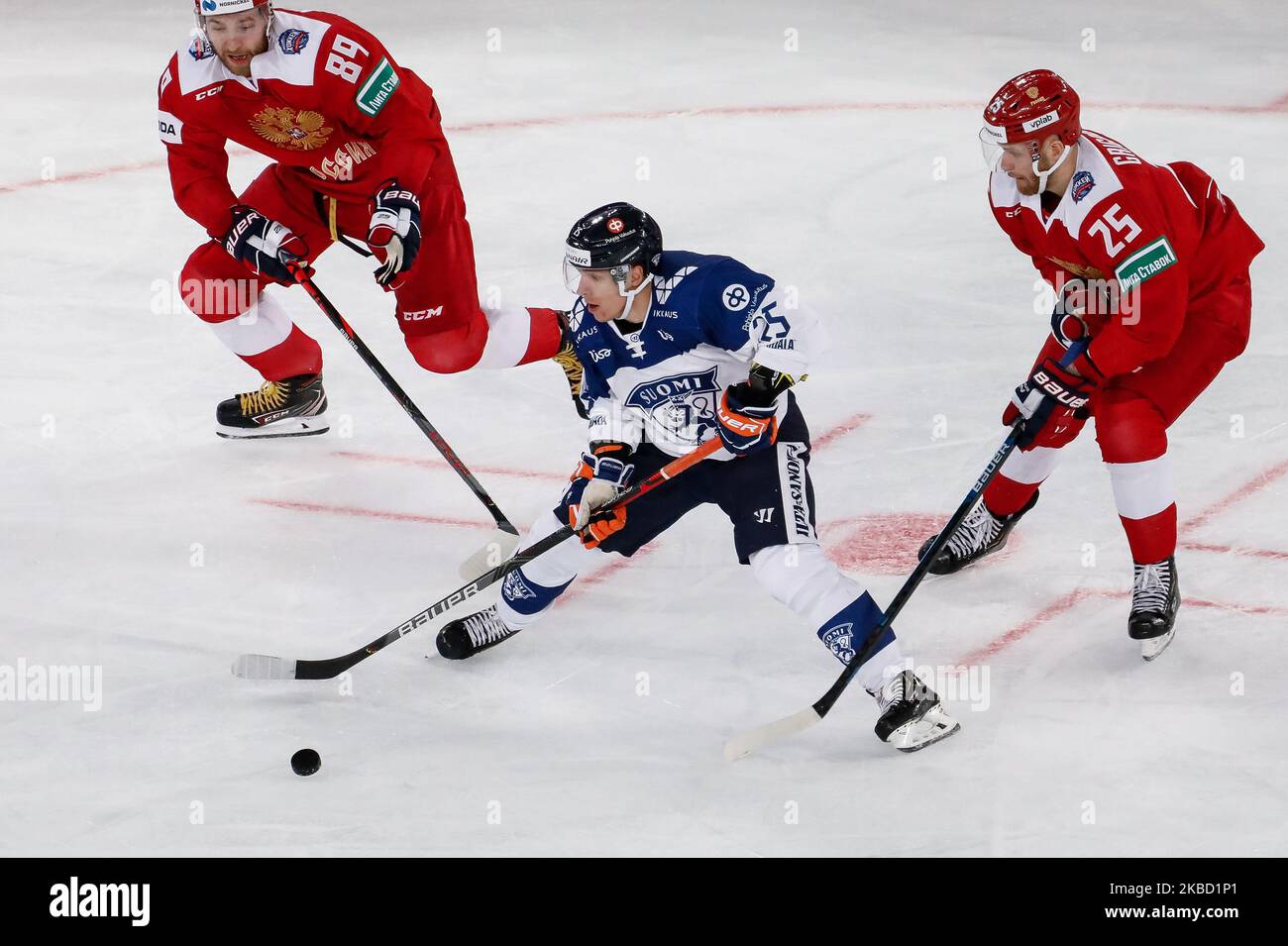 Jere Karjalainen (C) of Finland in action against Nikita Nesterov (L) and Mikhail Grigorenko of Russia during the Euro Hockey Tour Channel One Cup ice hockey match between Russia and Finland on December 15, 2019 at Gazprom Arena in Saint Petersburg, Russia. (Photo by Mike Kireev/NurPhoto) Stock Photo