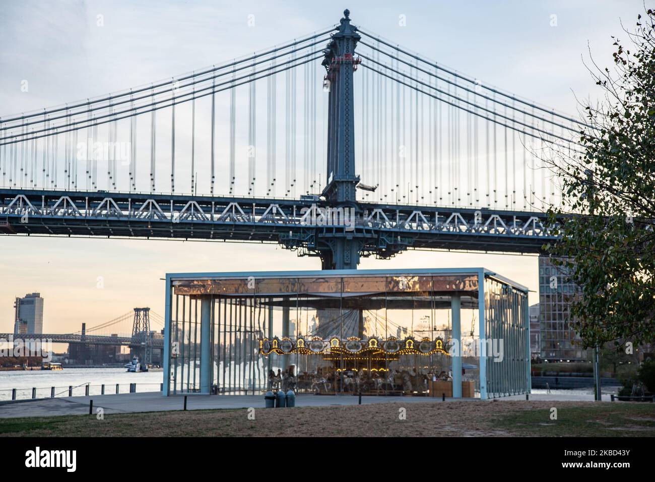 Early morning view of the iconic Manhattan Bridge from as seen from Dumbo district neighborhood in Brooklyn, NYC, USA on 14 November 2019. The 448m. long suspension bridge is a NY city landmark, tourist attraction, crossing East River and connecting Lower Manhattan to Downtown Brooklyn. The metallic iron bridge is active with traffic, 7 lanes of roadway and 4 train tracks for the subway and bicycles. It was opened to traffic in 1909, built by Phoenix Bridge Company and designed by Leon Moisseiff. (Photo by Nicolas Economou/NurPhoto) Stock Photo