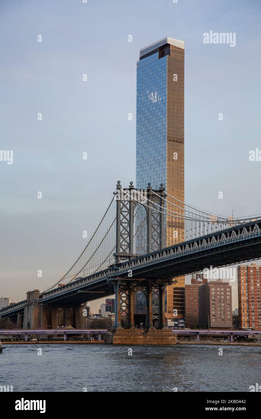 Early morning view of the iconic Manhattan Bridge from as seen from Dumbo district neighborhood in Brooklyn, NYC, USA on 14 November 2019. The 448m. long suspension bridge is a NY city landmark, tourist attraction, crossing East River and connecting Lower Manhattan to Downtown Brooklyn. The metallic iron bridge is active with traffic, 7 lanes of roadway and 4 train tracks for the subway and bicycles. It was opened to traffic in 1909, built by Phoenix Bridge Company and designed by Leon Moisseiff. (Photo by Nicolas Economou/NurPhoto) Stock Photo