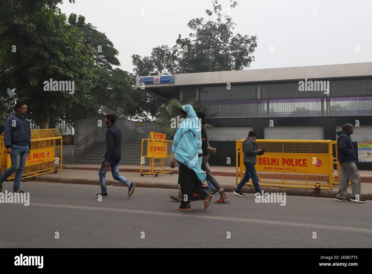 People walk near q closed metro station in New Delhi India following the protests on 19 December 2019. People march in Indian capital New Delhi Thursday in protest against the controversial citizenship bill that allegedly discriminates against minority Muslim community. Protest rallies were held across several major cities in the country even as government enforced ban on assembly of people in several cities. The protests have spiked since Sunday following the crackdown and violent police action on students in Jamia Milia Islamia university in New Delhi (Photo by Nasir Kachroo/NurPhoto) Stock Photo