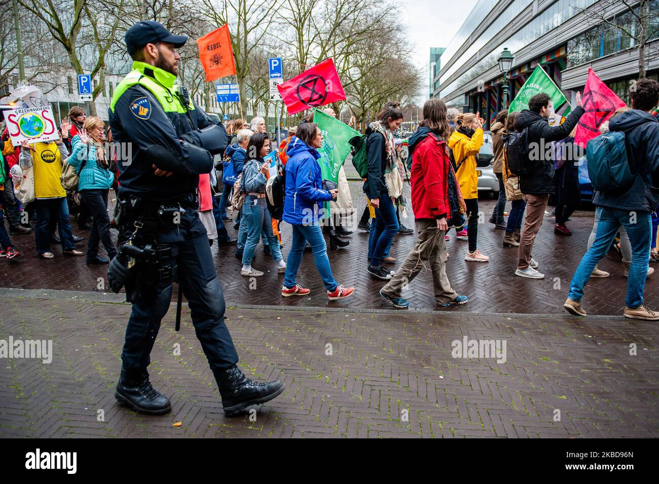 Police is accompanied the demonstration in support of the Urgenda case ...