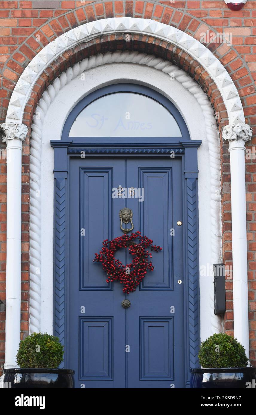 Christmas decorations and Christmas wreath seen on a door of a house in