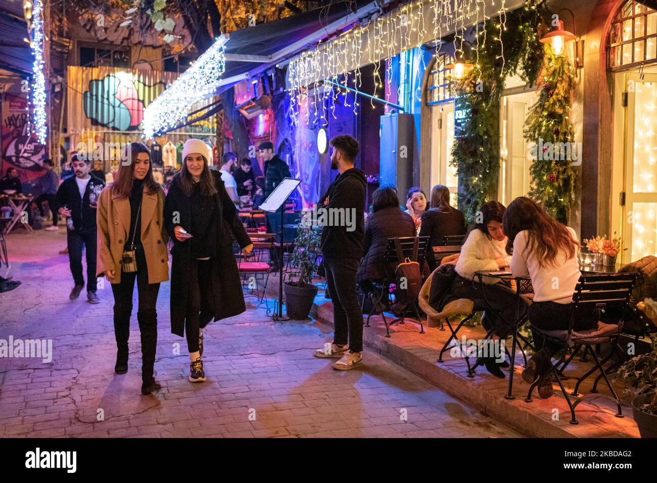 On 20 Dec. 2019, young Turkish women walked down a street lined with bars and restaurants in the nightlife district of Karakoy in Istanbul, Turkey on a Friday night. (Photo by Diego Cupolo/NurPhoto) Stock Photo
