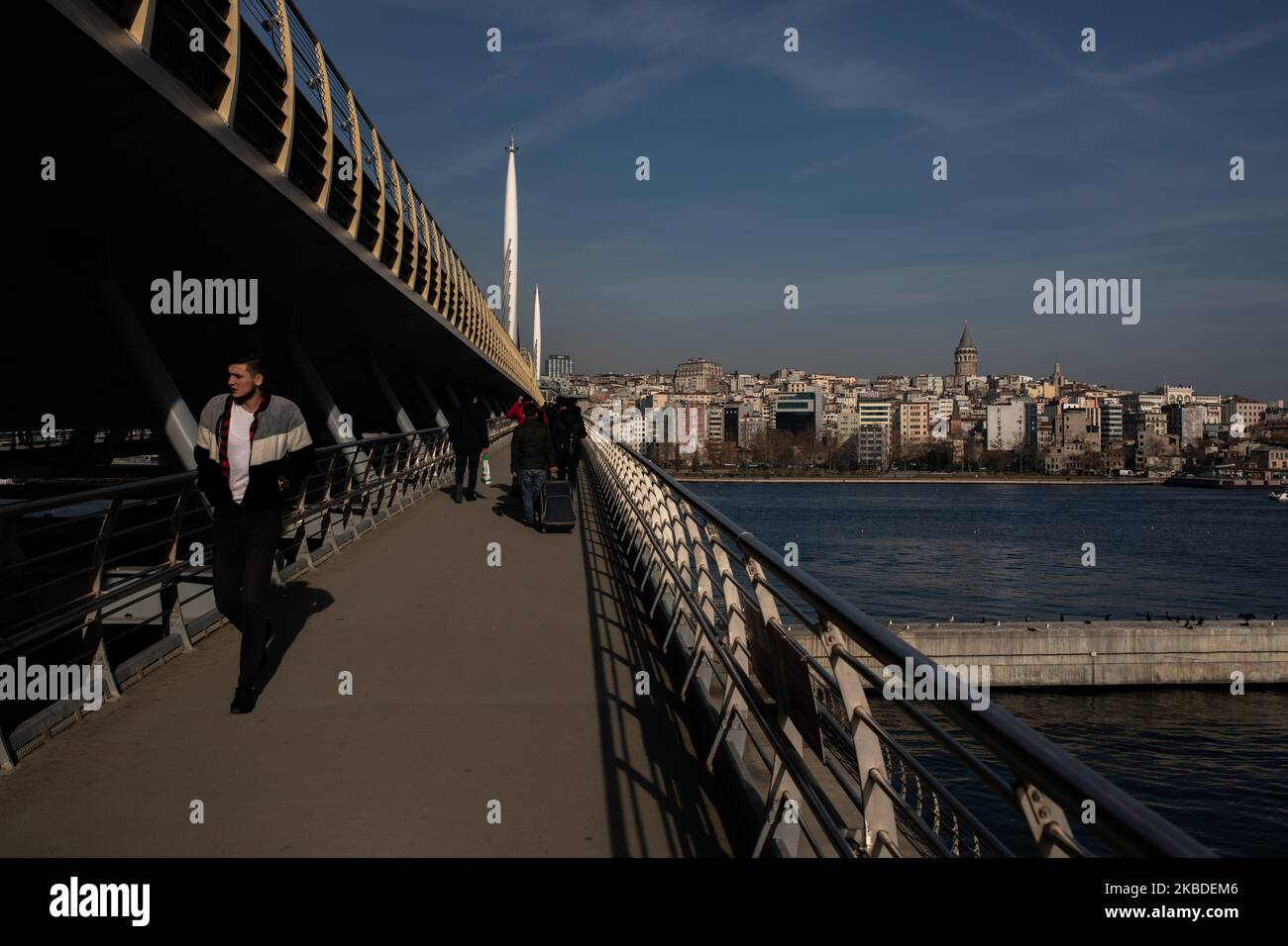 People walking across the Golden Horn Beidge, also named as Halic Bridge in Istanbul, Turkey on Decemver 25, 2019According to Turkish Statistical Institute (TUIK), 3161 people have committed suicide in 2018, and the number kept increasing throughout 2019. The main causes are reported as 'diseases, economic crisis and family issues'. (Photo by Erhan Demirtas/NurPhoto) Stock Photo
