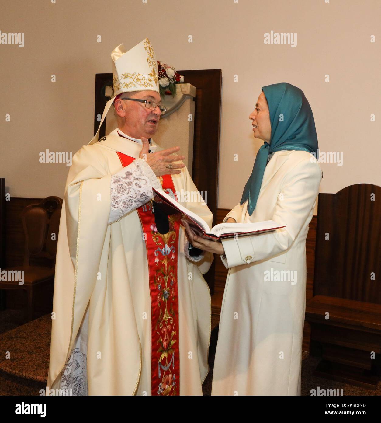 Maryam Rajavi, the President-elect of the National Council of Resistance of Iran (NCRI) and George Antonio Frendo, Archbishop of Tirana and Duress, on December 25, 2019 in Tirana. She presenting a book containing the list of names of 20,000 members of the People's Mojahedin Organization of Iran executed by the Iranian regime, during Christmas celebrations marking the birth of Jesus Christ at the Metropolitan Archdiocese of Tirana- Durres. (Photo by Siavosh Hosseini/NurPhoto) Stock Photo