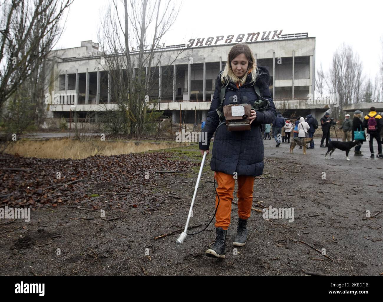 A visitor measures the level of radiation in an abandoned city of ...