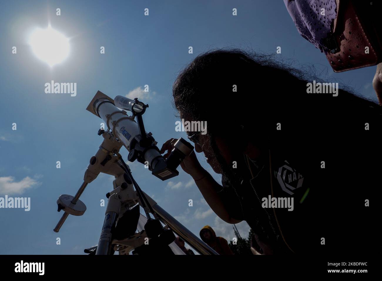 A number of citizens and foreign tourists witnessed the natural phenomenon of the solar eclipse in Rbat archipelago, Indonesia on December 26, 2019. Solar eclipse is a mathari event, the moon and the earth are located in a straight line and the moon is between the sun and the earth so that the sun's light is blocked by the moon either in part or in whole (Photo by Teguh Prihatna/NurPhoto) Stock Photo