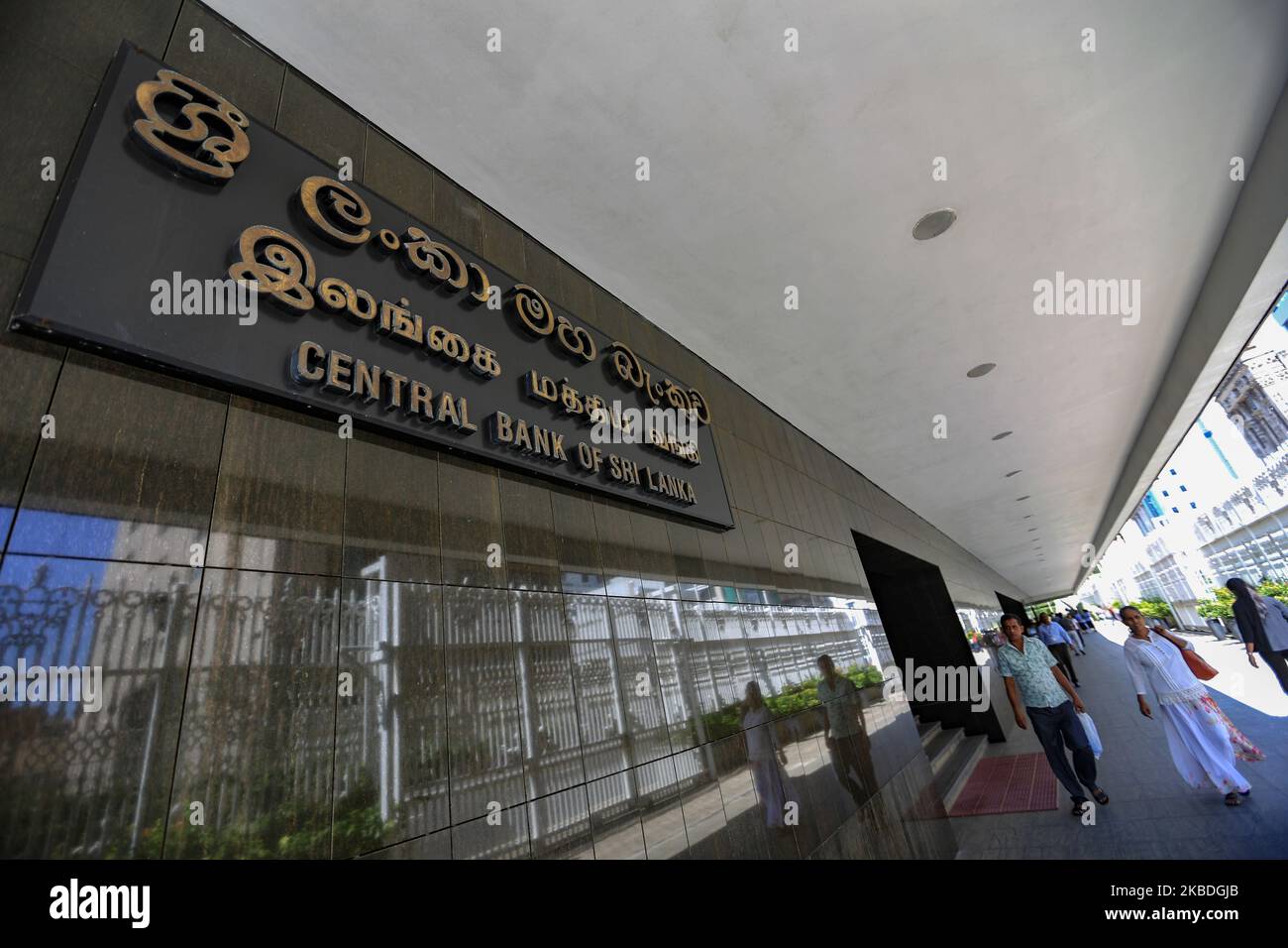 People walk pass the main entrance at the Central Bank Head Quarters at