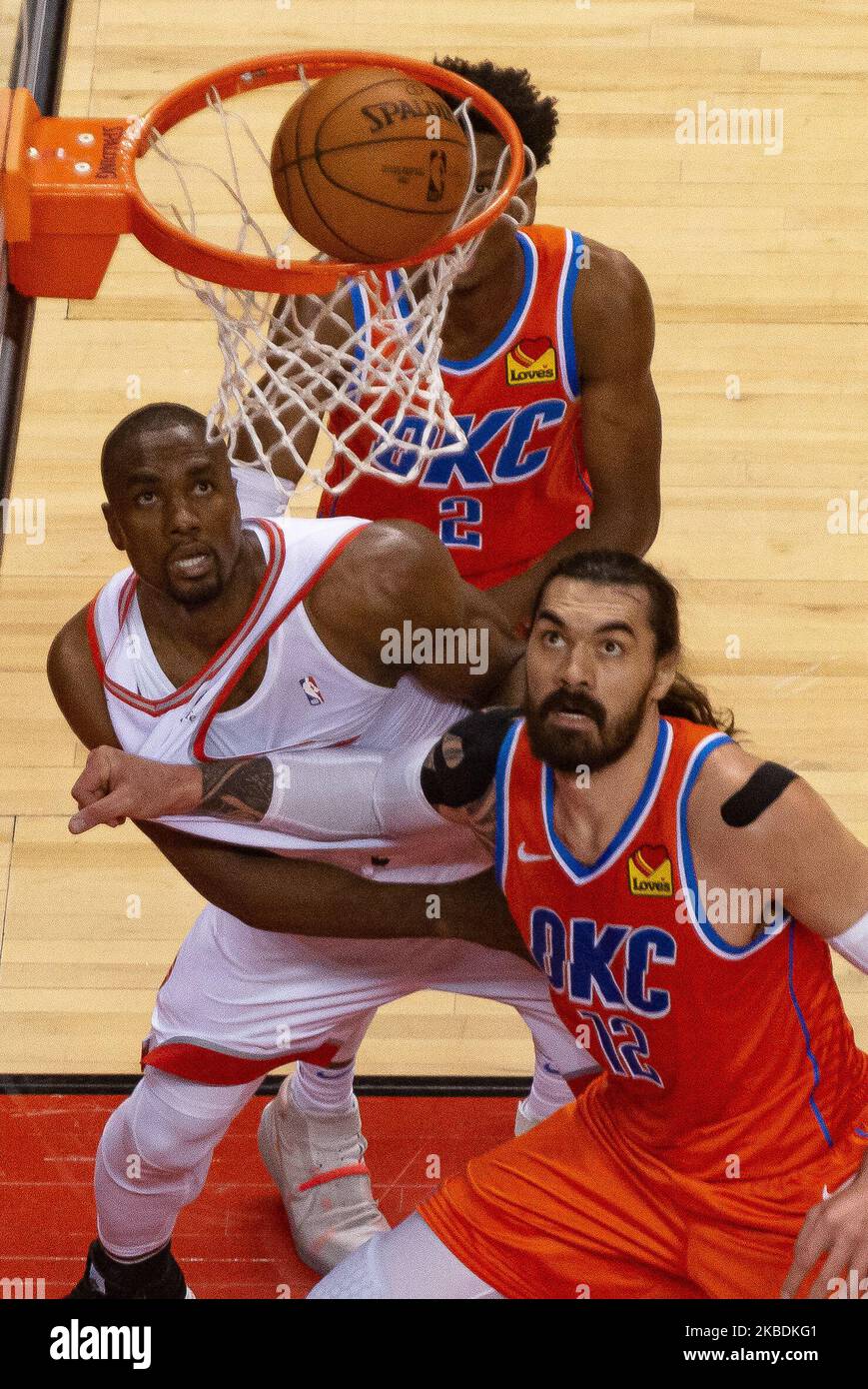Steven Adams #12 of the Oklahoma City Thunder and Serge Ibaka #9 of the Toronto Raptors look at the ball under the basket during the Toronto Raptors vs Oklahoma City Thunder NBA regular season game at Scotiabank Arena on December 29, 2019, in Toronto, Canada (Oklahoma City Thunder won 98:97) (Photo by Anatoliy Cherkasov/NurPhoto) Stock Photo