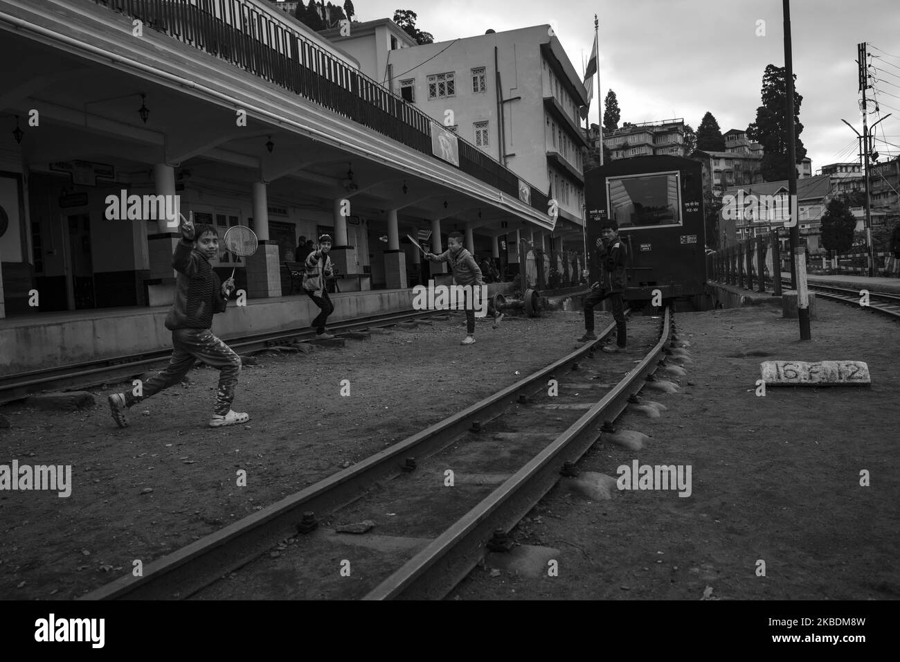 (EDITOR'S NOTE: Image was converted to black and white) Local children are playing during the afternoon on the tracks in Darjeeling, India on 20th Dec'19. Darjeeling Himalayan Railway is one of the oldest two feet gauge railway in India which was settled by the British. Now it has been declared as a UNESCO World Heritage site on 5th December 1999. (Photo by Dipayan Bose/NurPhoto) Stock Photo
