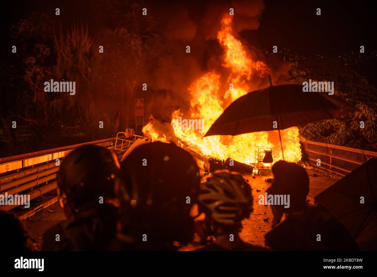 Protestors burning improvise roadblock to stop police attack on Nov 12, 2019. Battle of Number two bridge in the Chinese University of Hong Kong. Police entering University and student push back the police. (Photo by Kwan Wong/NurPhoto) Stock Photo