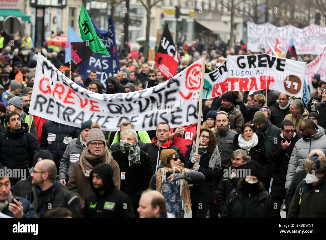 Protestors hold a banner reading 'Strike is better than a meagre pension' during a demonstration called by French national trade union General Confederation of Labour (CGT) against the pension reform on January 4, 2020, on the Place de la Republique in Paris. After 30 days of strike, unions opposed to the pension reform promise not to give respite next week to the government, before the resumption of consultations on January 7,2020. (Photo by Michel Stoupak/NurPhoto) Stock Photo