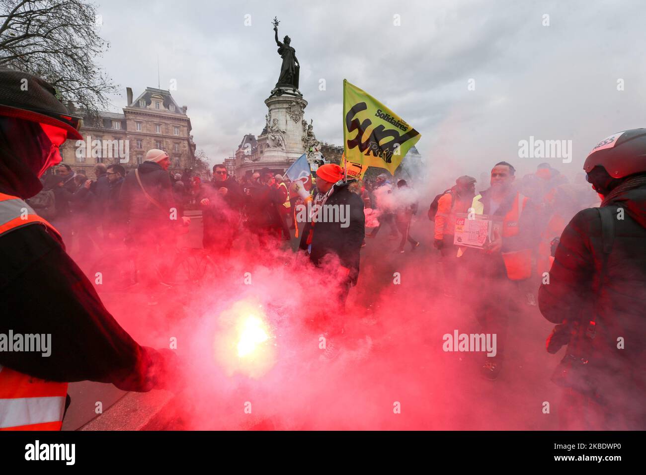 Striking railway workers holds red flares during a demonstration called by French national trade union General Confederation of Labour (CGT) against the pension reform on January 4, 2020, on the Place de la Republique in Paris, on January 4, 2020. After 30 days of strike, unions opposed to the pension reform promise not to give respite next week to the government, before the resumption of consultations on January 7,2020. (Photo by Michel Stoupak/NurPhoto) Stock Photo