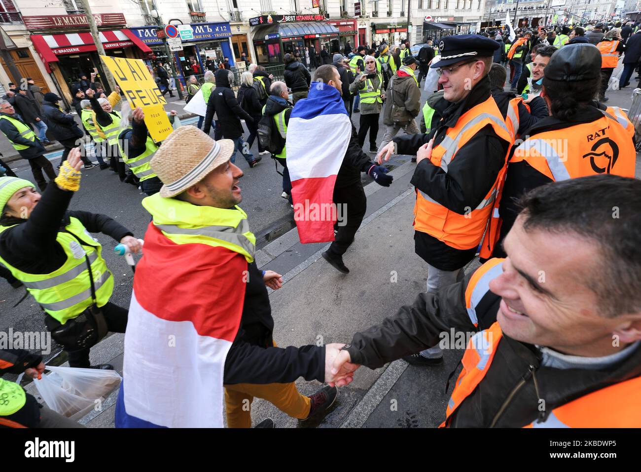 Striking railway workers wearing an orange vest of Paris' RATP public transport operator fraternises with yellow vests during a demonstration called by French national trade union General Confederation of Labour (CGT) against the pension reform on January 4, 2020, in front of the Gare de Lyon train station in Paris, on January 4, 2020. After 30 days of strike, unions opposed to the pension reform promise not to give respite next week to the government, before the resumption of consultations on January 7,2020. (Photo by Michel Stoupak/NurPhoto) Stock Photo