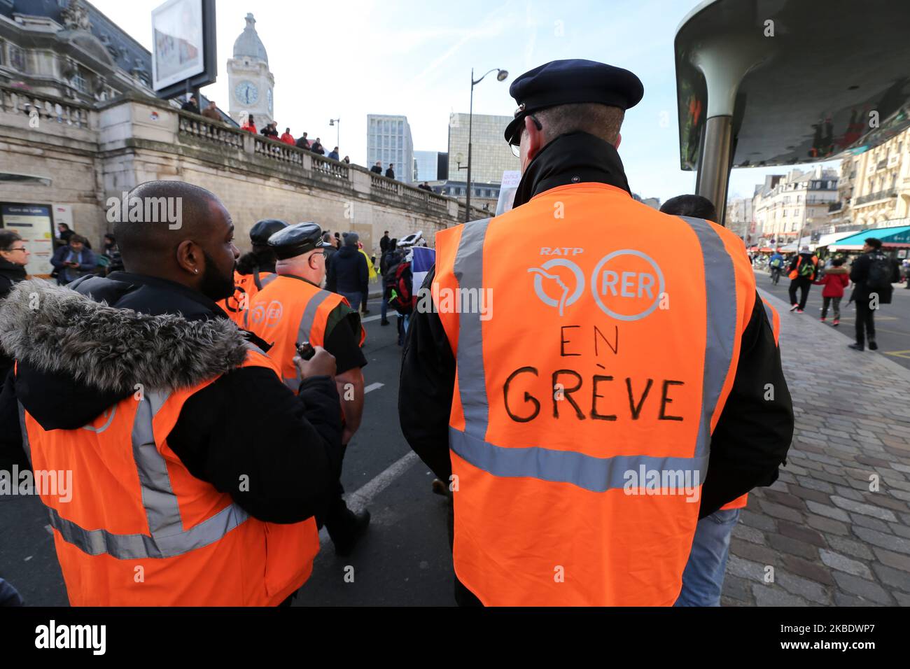 Striking railway workers wearing an orange vest of Paris' RATP public transport operator take to the street during a demonstration called by French national trade union General Confederation of Labour (CGT) against the pension reform on January 4, 2020, in front of the Gare de Lyon train station in Paris, on January 4, 2020. After 30 days of strike, unions opposed to the pension reform promise not to give respite next week to the government, before the resumption of consultations on January 7,2020. (Photo by Michel Stoupak/NurPhoto) Stock Photo