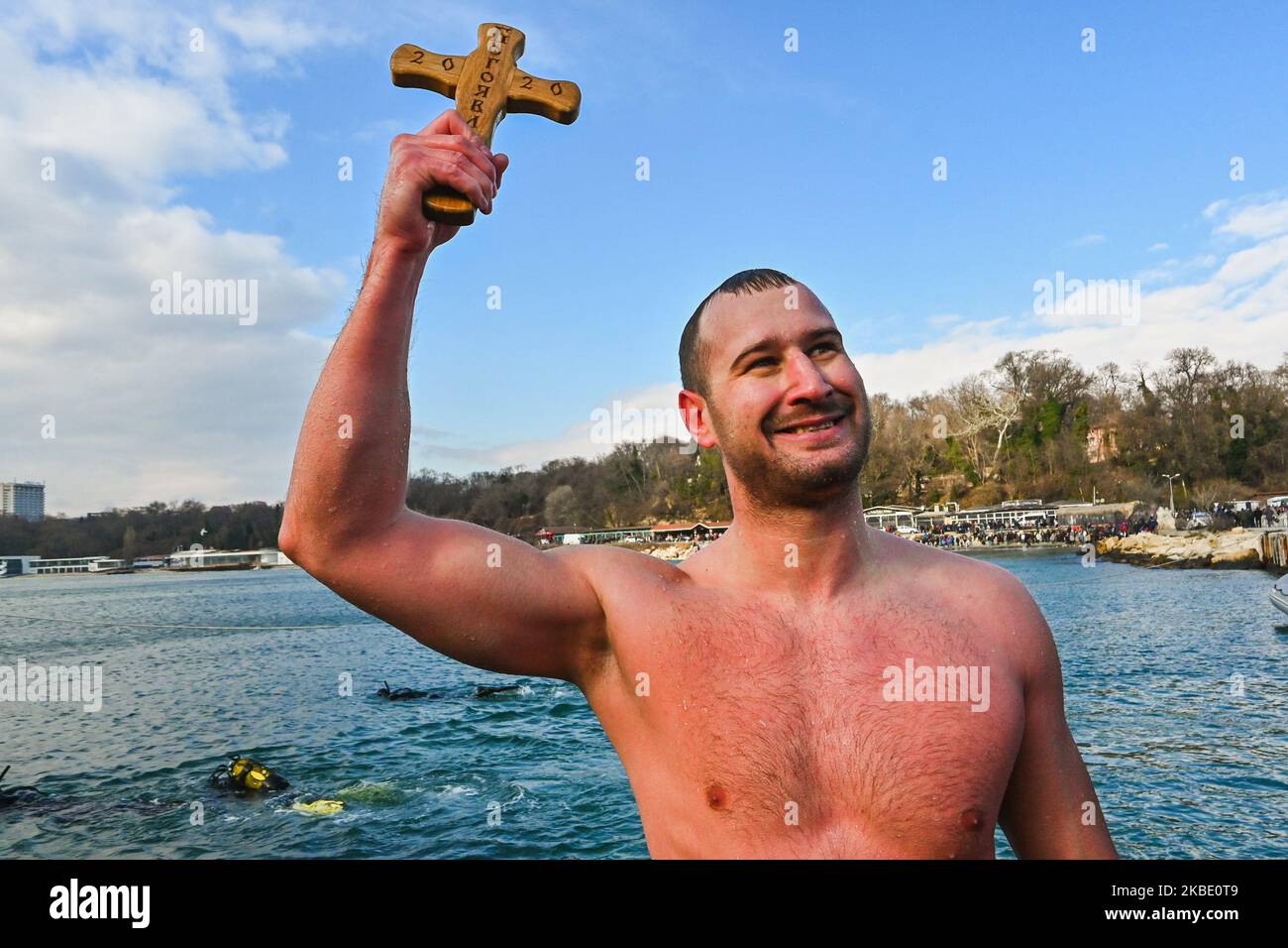 Bulgarians plunge into the icy winter water of the Black sea, to catch a cross during the Epiphany Day celebrations' on 6 January 2020 in Varna, Bulgaria. As a tradition, an Eastern Orthodox priest throws a cross in the river and it is believed that the one who retrieves it will be healthy through the year as well as all those who dance in the icy water. (Photo by: Impact Press Group/NurPhoto) Stock Photo