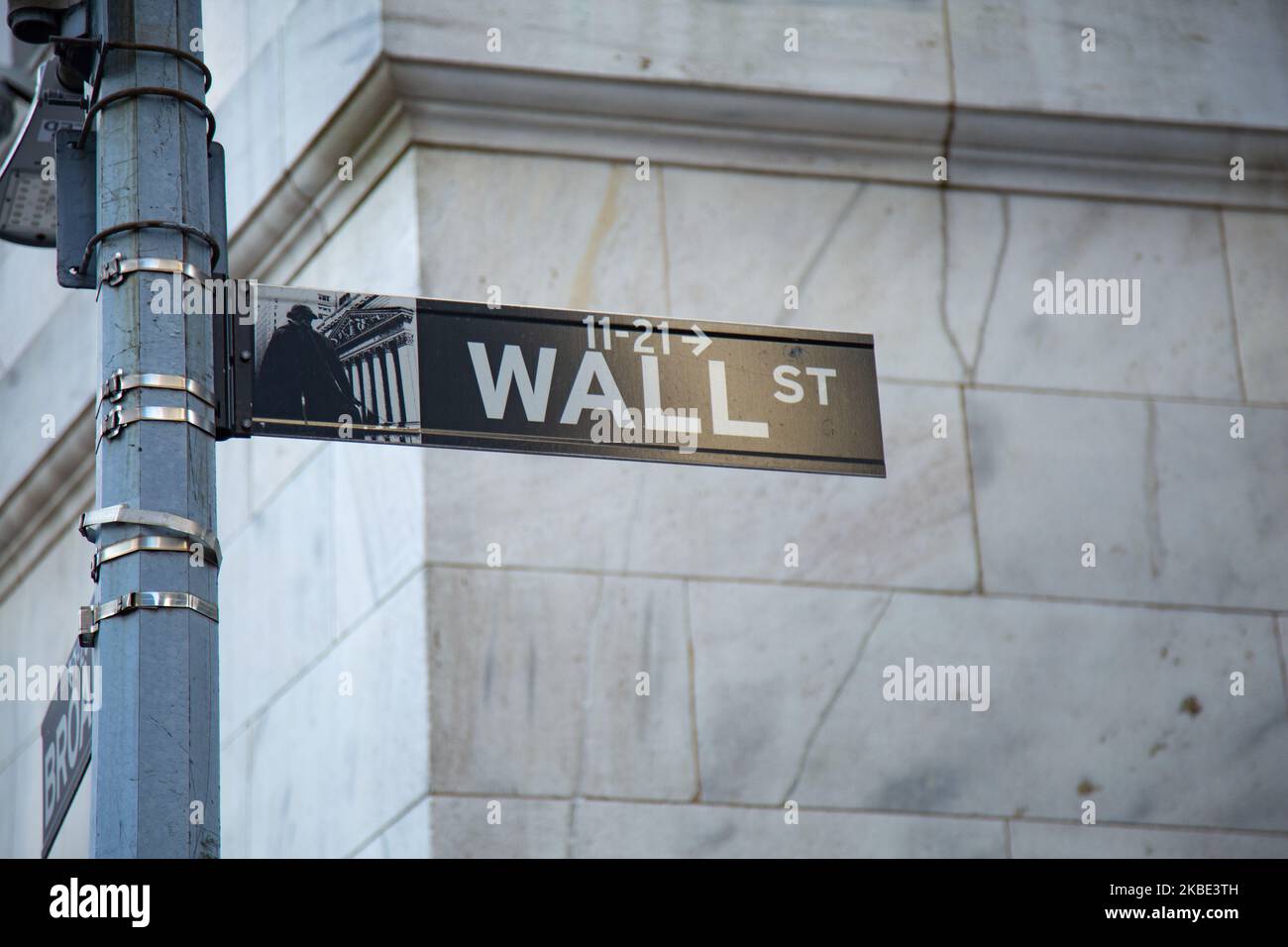 Wall Street sign inscription as seen on various buildings, Wall St address, Downtown in lower Manhattan is a significant road and area district for the American, the global economy, banking system, markets etc with headquarters of companies and financial institutions located there like the New York Stock Exchange NYSE. New York City, USA (Photo by Nicolas Economou/NurPhoto) Stock Photo