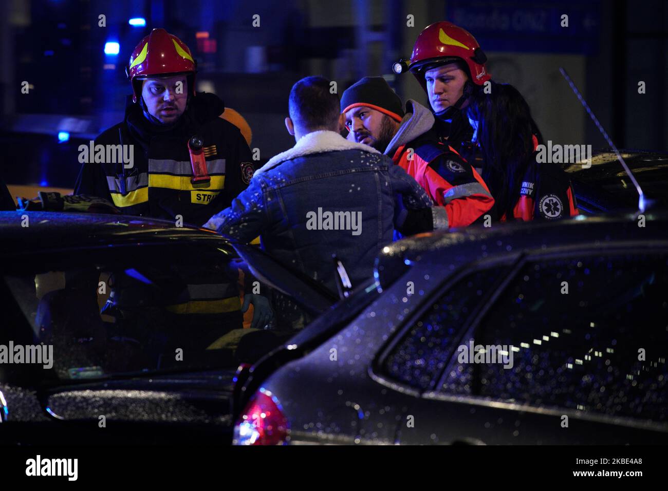 A man is helped by members of the fire brigade after a car collission in Warsaw, Poland on January 8, 2020. Four cars crashed into each other on Wednesday evening in the city's main main high-capacity road. No serious casualties have been reported despite heavy damage to vehicles. (Photo by Jaap Arriens/NurPhoto) Stock Photo