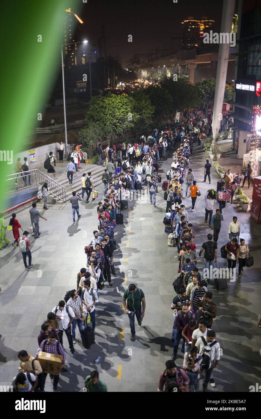People que in the line after working hours to enter the Huda City Centre metro station in Gurugram, India on October 25, 2019. (Photo by Krystof Kriz/NurPhoto) Stock Photo