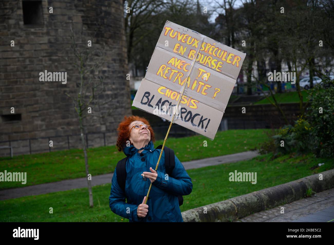 Demonstrator with a sign denouncing BlackRock and the opening towards the capitalization of the pension system during the demonstration against the pension reform project on January 9, 2020 in Nantes, France (Photo by Estelle Ruiz/NurPhoto) Stock Photo