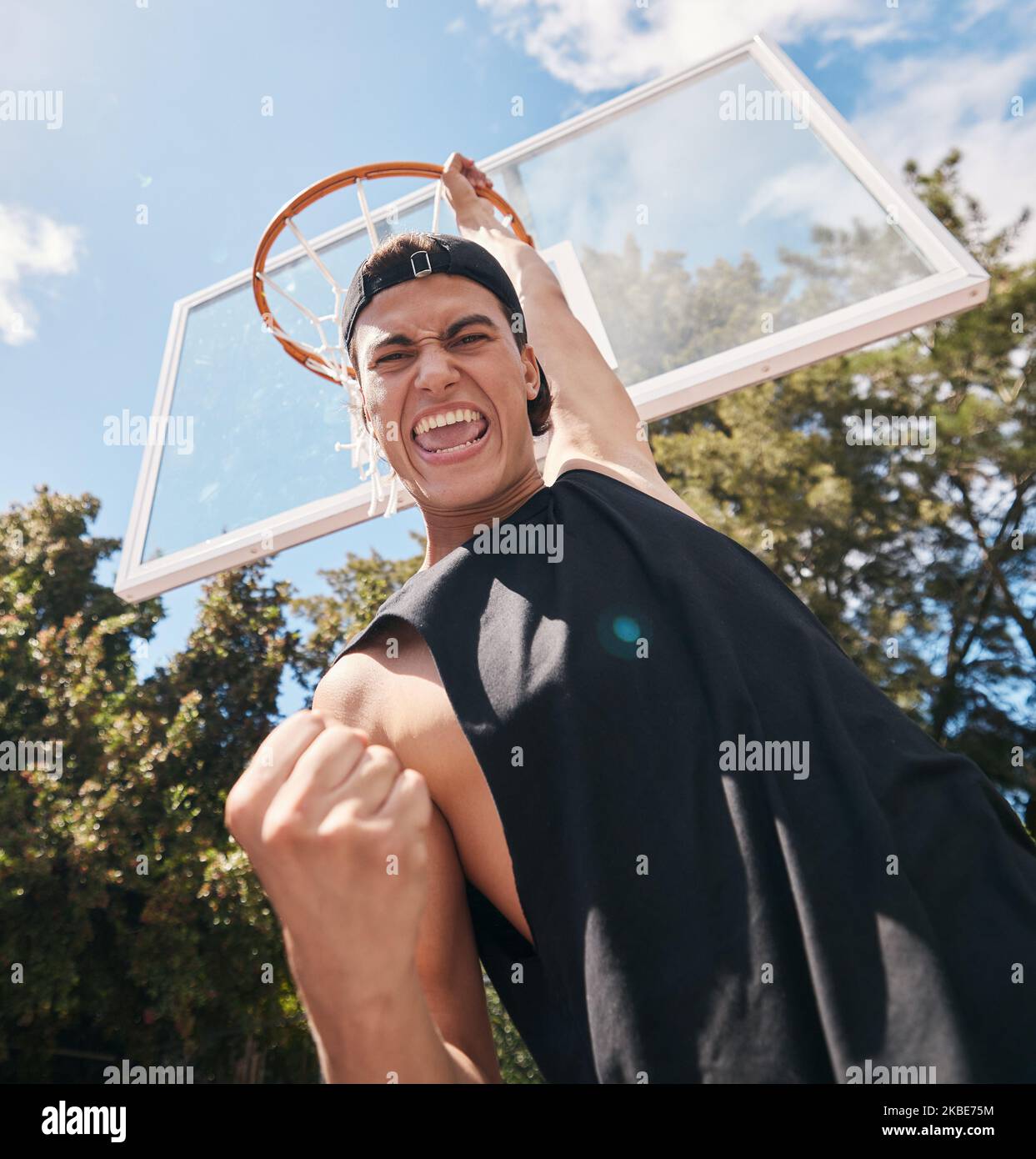 Basketball, man and winner in score for sports game, celebration or match in the court outdoors. Excited, energetic male basketball player celebrating Stock Photo