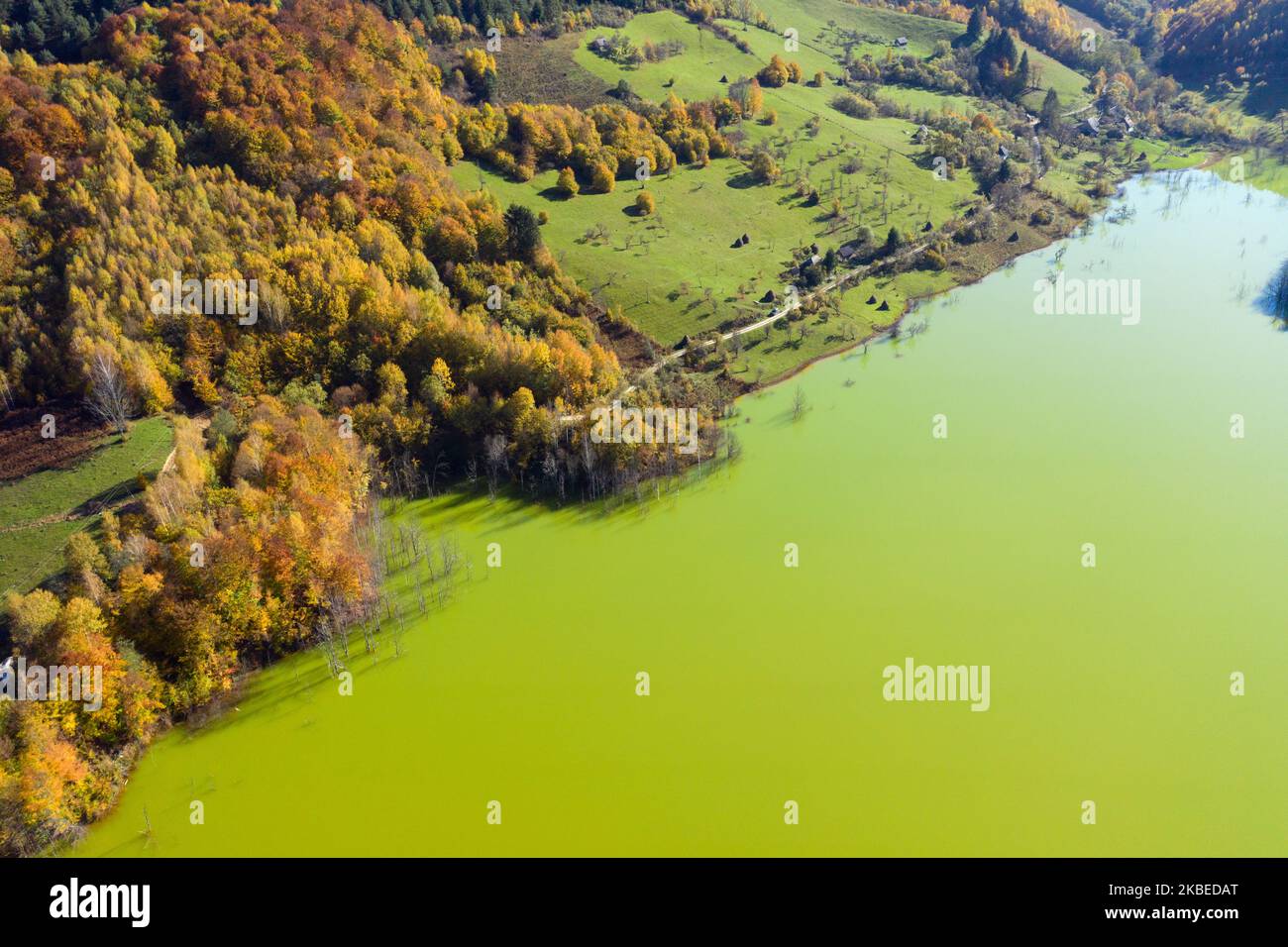 Aerial view of green mine waters from a copper mine flooding natural habitat. Geamana, Romania Stock Photo