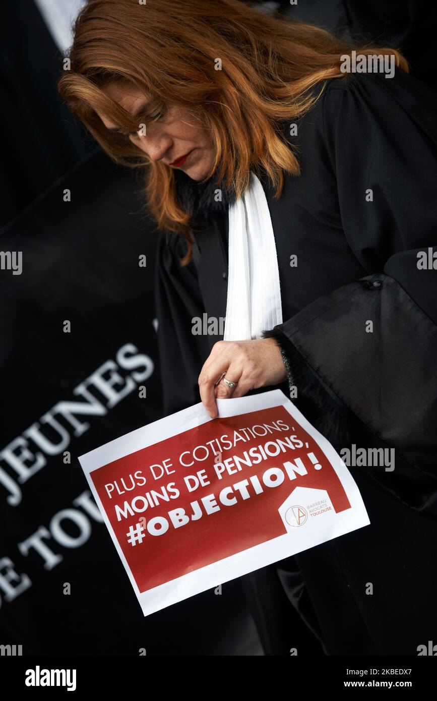 A lawyer holds a placard reading 'more contributions, less pensions, objection !''. Lawyers gathered in front of the Court House of Toulouse to protest against the planned Macron's retirement reform. Their contributions to the retirement system will double (14% to 28%) but for a pension 30% lower. The Macron's gouvernement plans to change the retirement system pay-as-you-go by a system by points (capitalization). Toulouse. France. January 13th 2020. (Photo by Alain Pitton/NurPhoto) Stock Photo