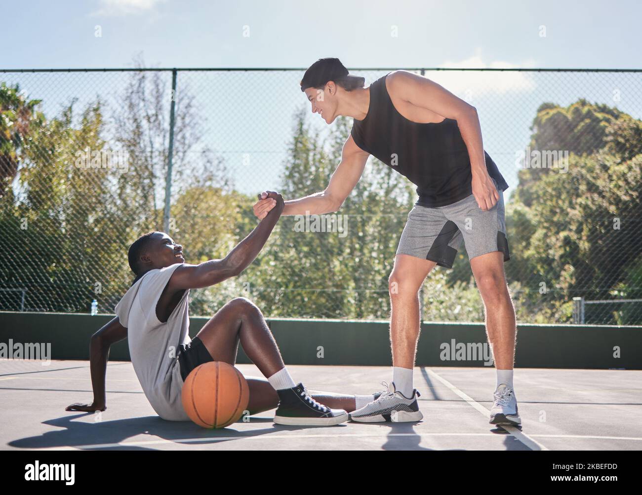 Sports, teamwork and men with helping hand in basketball, player giving