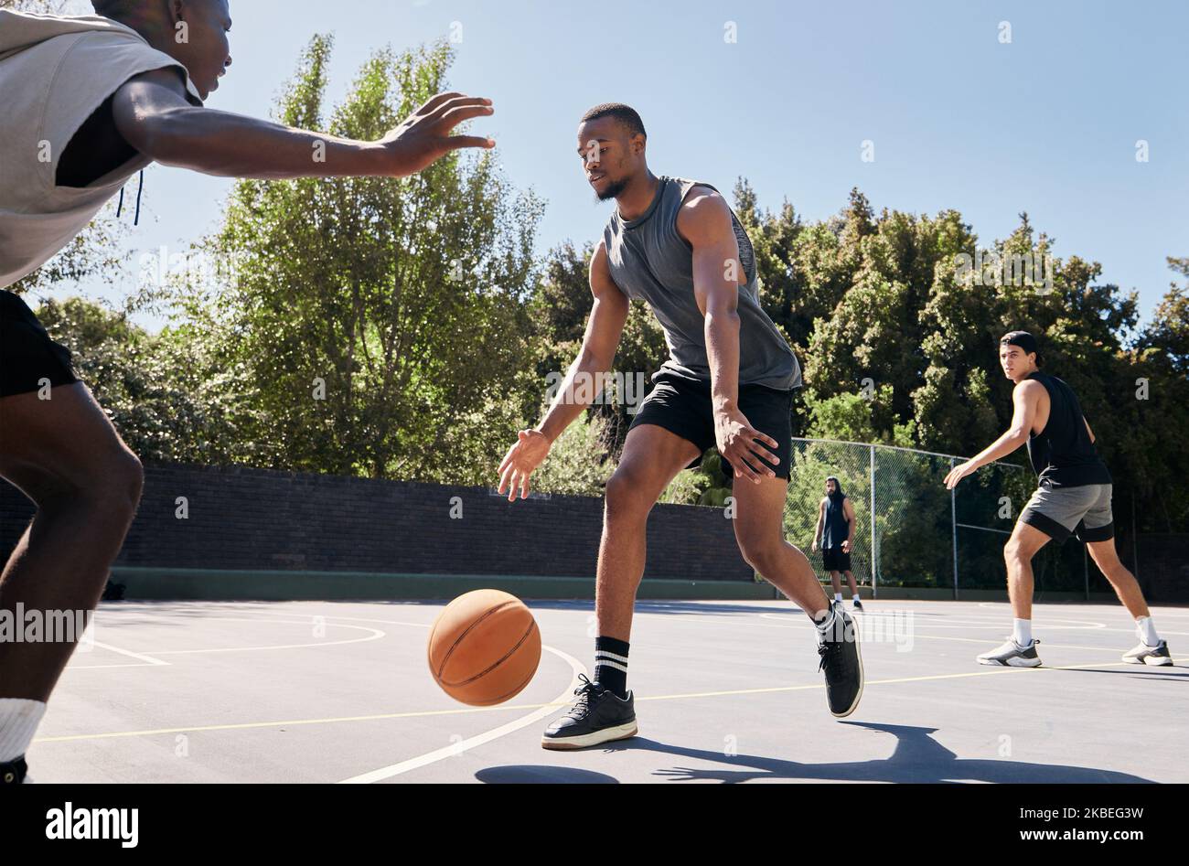 Fitness, basketball and athlete on an outdoor court playing a match or training as a team