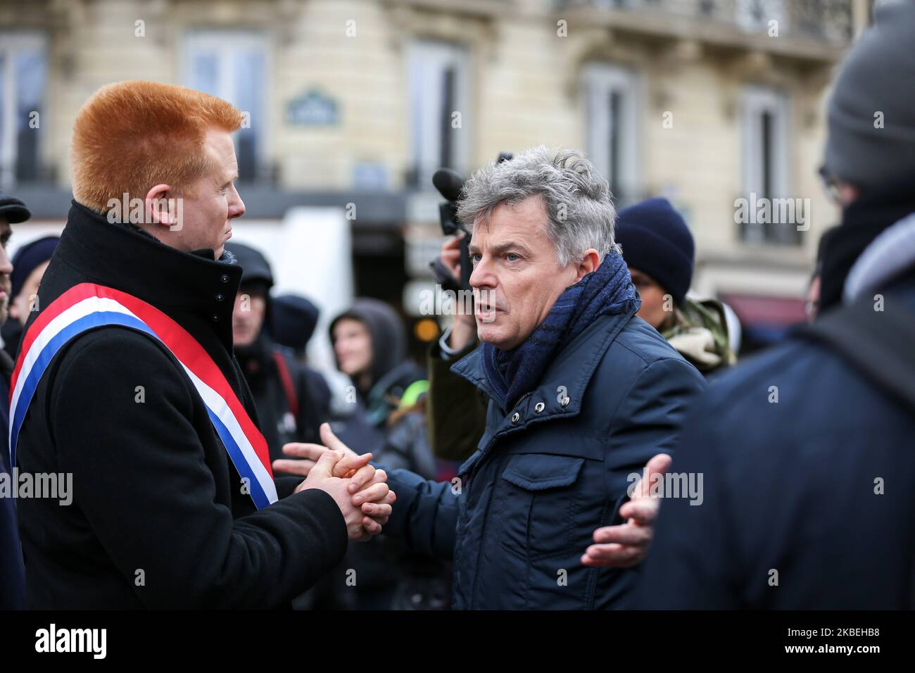 French leftist party La France Insoumise (LFI) MP Adrien Quatennens (L) speaks with Communist party member of Parliament Fabien Roussel (C) as they take part in a demonstration in front the Tour Eiffel in Paris on January 14, 2020, as part of a nationwide multi-sector strike against the French government's pensions overhaul. A transport strike dragged on into its 41st day on January 14, with both the French government and hardline unions digging in on the pension reforms that sparked the standoff. (Photo by Michel Stoupak/NurPhoto) Stock Photo