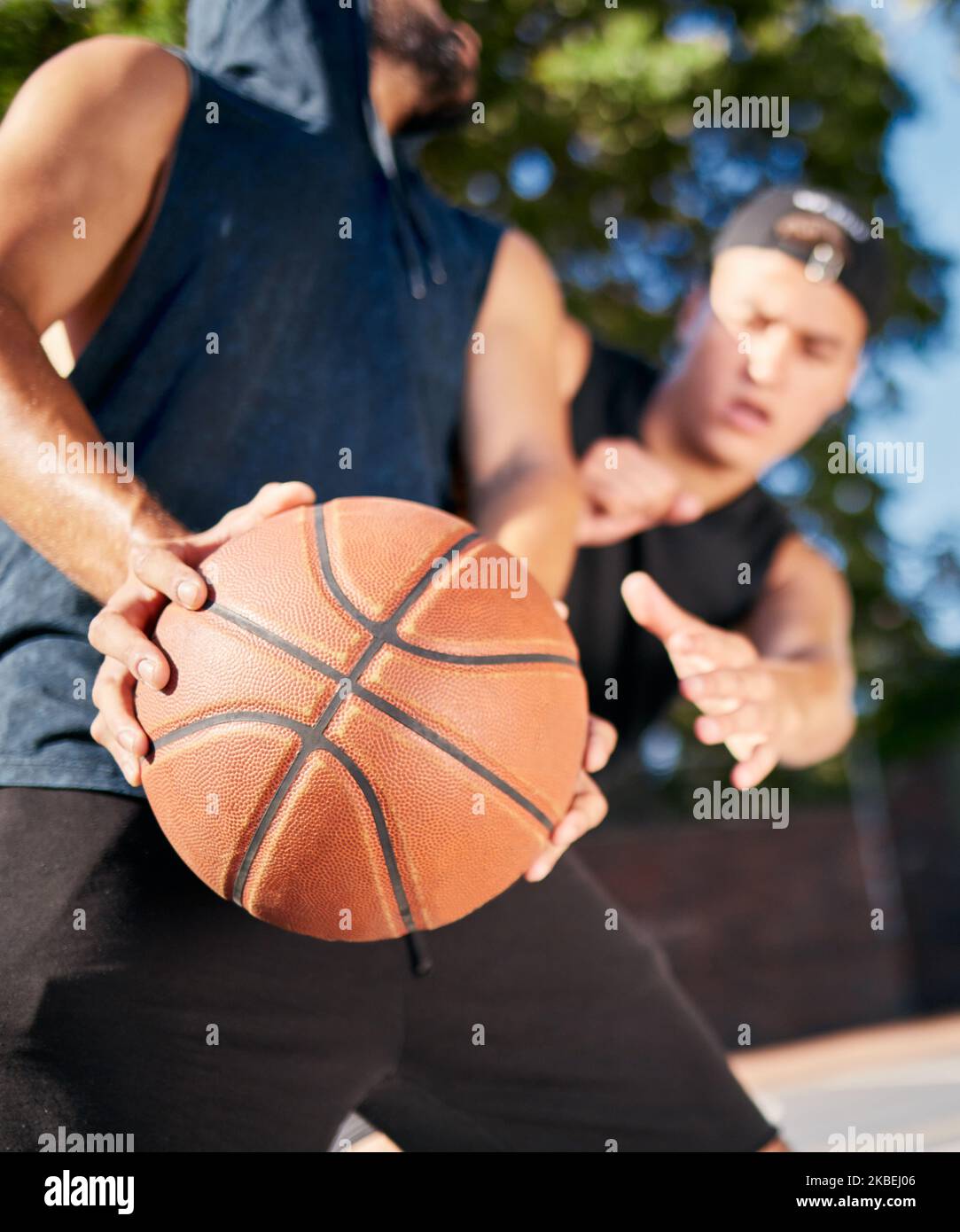Basketball player, dribble carry ball and playing on basketball court for fitness, heal and training. Basketball friends, outdoor summer sports and Stock Photo