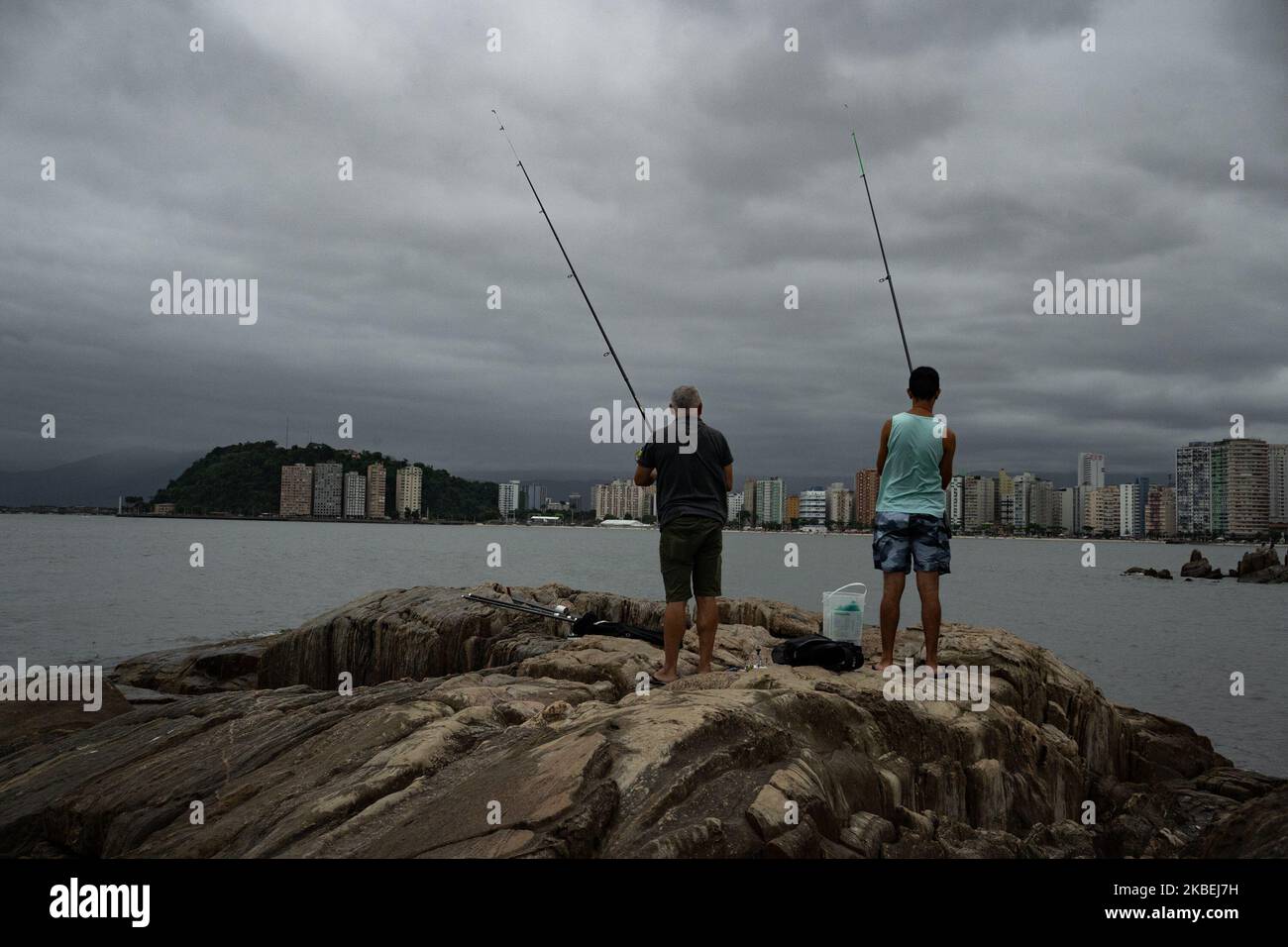 Two man rod fishing at Millionaires beach in Sao Vicente, Brazil on January 14, 2020. (Photo by Felipe Beltrame/NurPhoto) Stock Photo