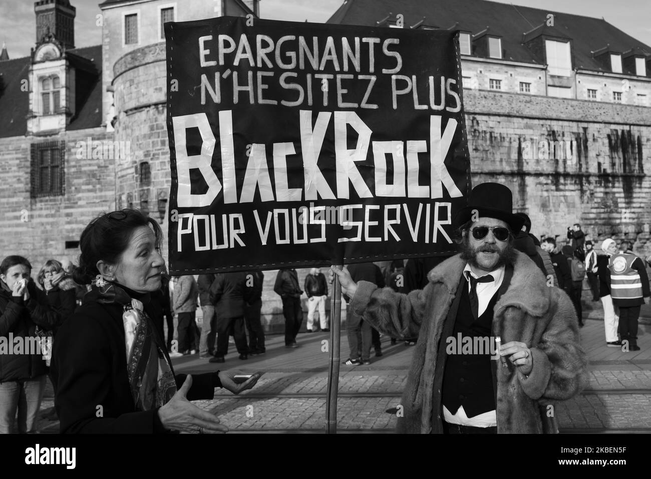 (EDITOR'S NOTE: Image was converted to black and white) About 10,000 people marched on January 16, 2020, in Nantes, France following the call of the CGT, FO, FSU and Solidaires unions to demonstrate news throughout the country and to continue the mobilization to request withdrawal of the reform reform project points retreat. For this day of mobilization, reformist unions such as the CFDT had not called to demonstrate given the 'temporary' withdrawal of the pivotal age at 64. In picture: Protester denouncing the company BlackRock paving the way for the capitalization of the pension system (Phot Stock Photo