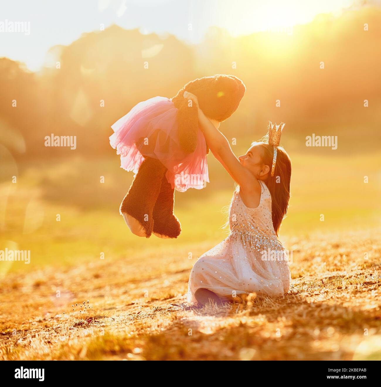 I cherish you above all my dolls. an adorable little girl playing with her teddybear outdoors. Stock Photo