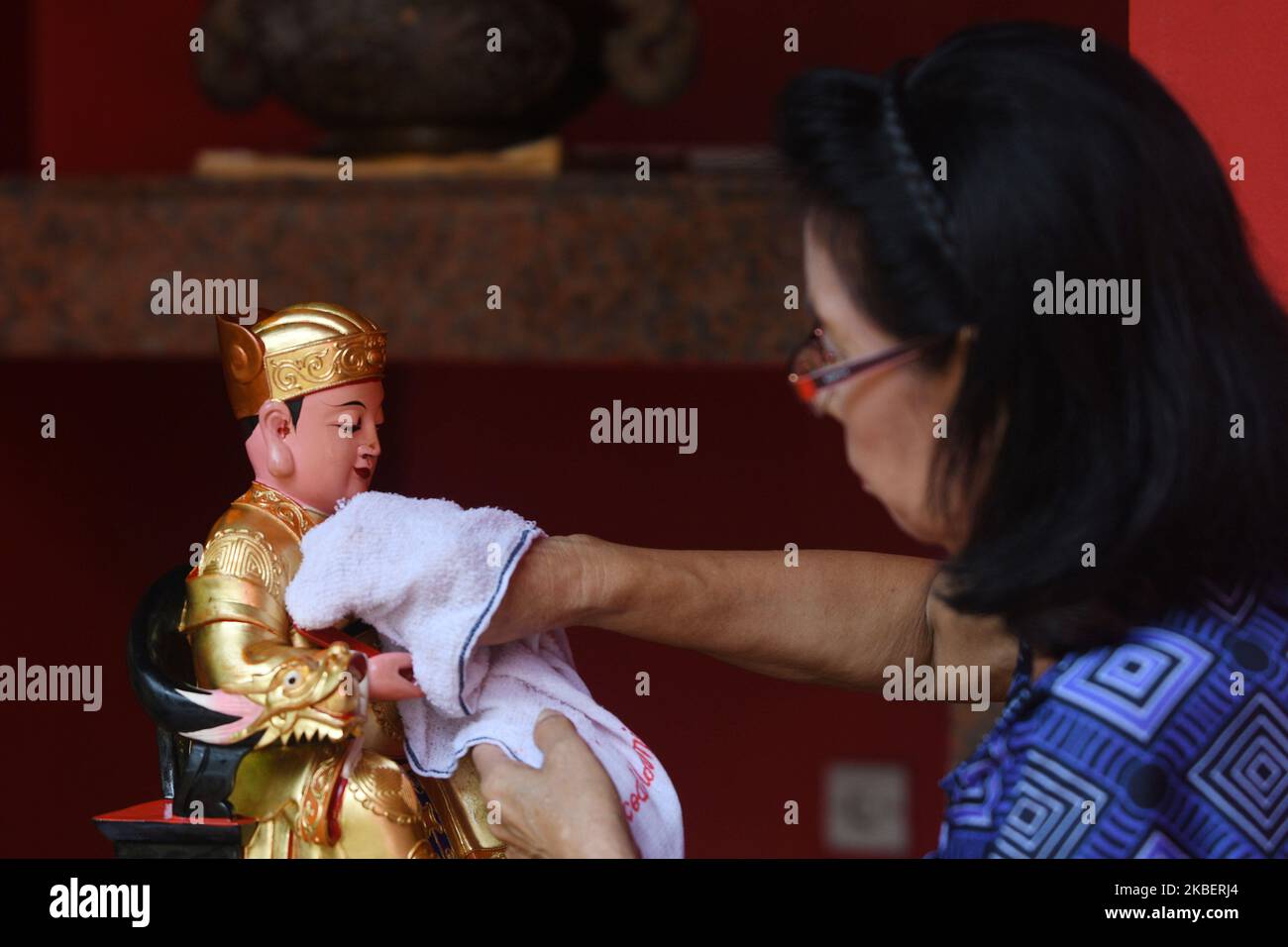 Residents of Chinese descent bathe statues or images of gods and goddesses, and clean up various prayer equipment at the klenteng Kong Miao , Taman Mini area, Jakarta, on January 18, 2020. The tradition that is carried out every year before the Chinese New Year is believed to add to the solemn and smooth procession of prayers performed by Chinese citizens. (Photo by Dasril Roszandi/NurPhoto) Stock Photo